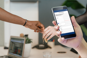 Example of ServiceTicket KEY - front: mobile phone with desired appointment information on the display, hands handing over a key in the background